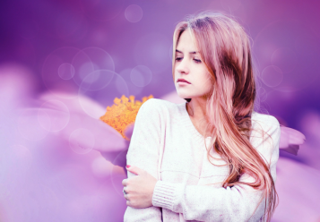 Girl posing with a purple flower background