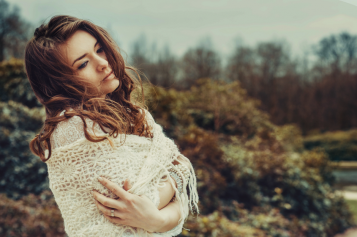 A woman posing for a photo in nature 