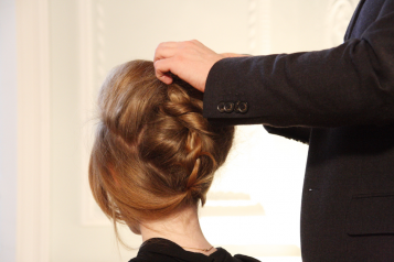 A person sorting out someones hair 