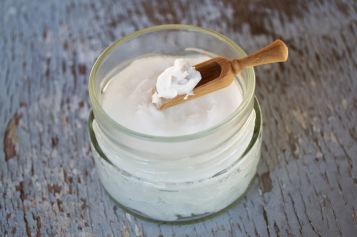 A pot of cream on a wooden table