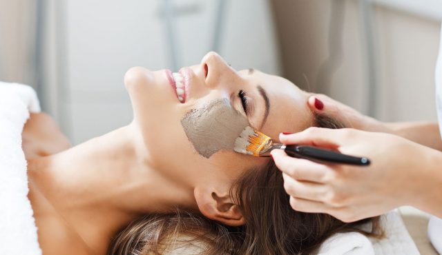 Woman with facial mask in beauty salon