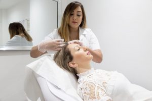 Sanna Mirza performing a treatment on a woman in a beauty therapy room