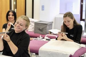 Three Beauty technicians in training at Ray Cochrane Beauty School